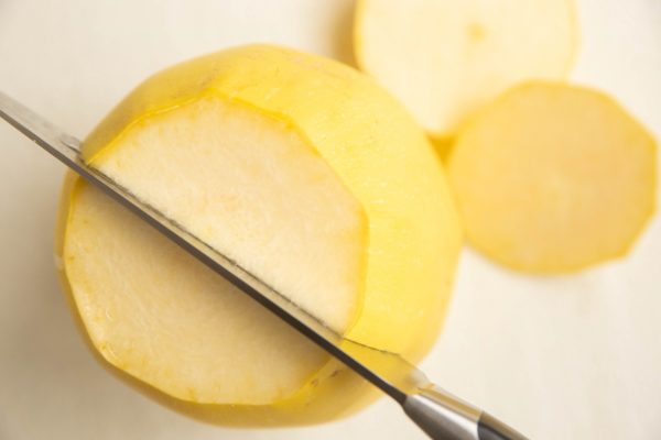 knife slicing a spaghetti squash in half