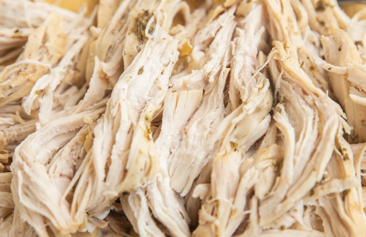 Shredded chicken on a cutting board.