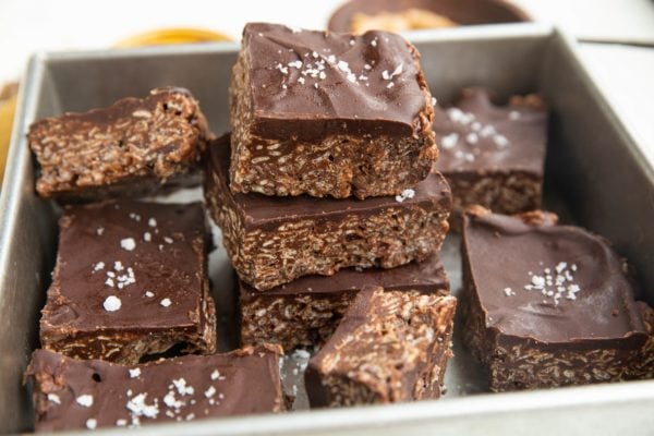 Horizontal photo of peanut butter rice krispie treats stacked up in a baking pan.