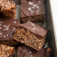 Cut bars of crispies treats in a baking dish.