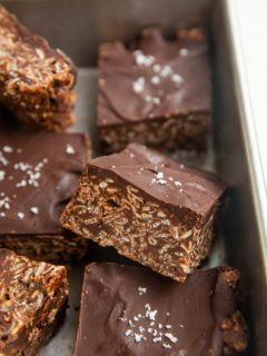 Cut bars of crispies treats in a baking dish.