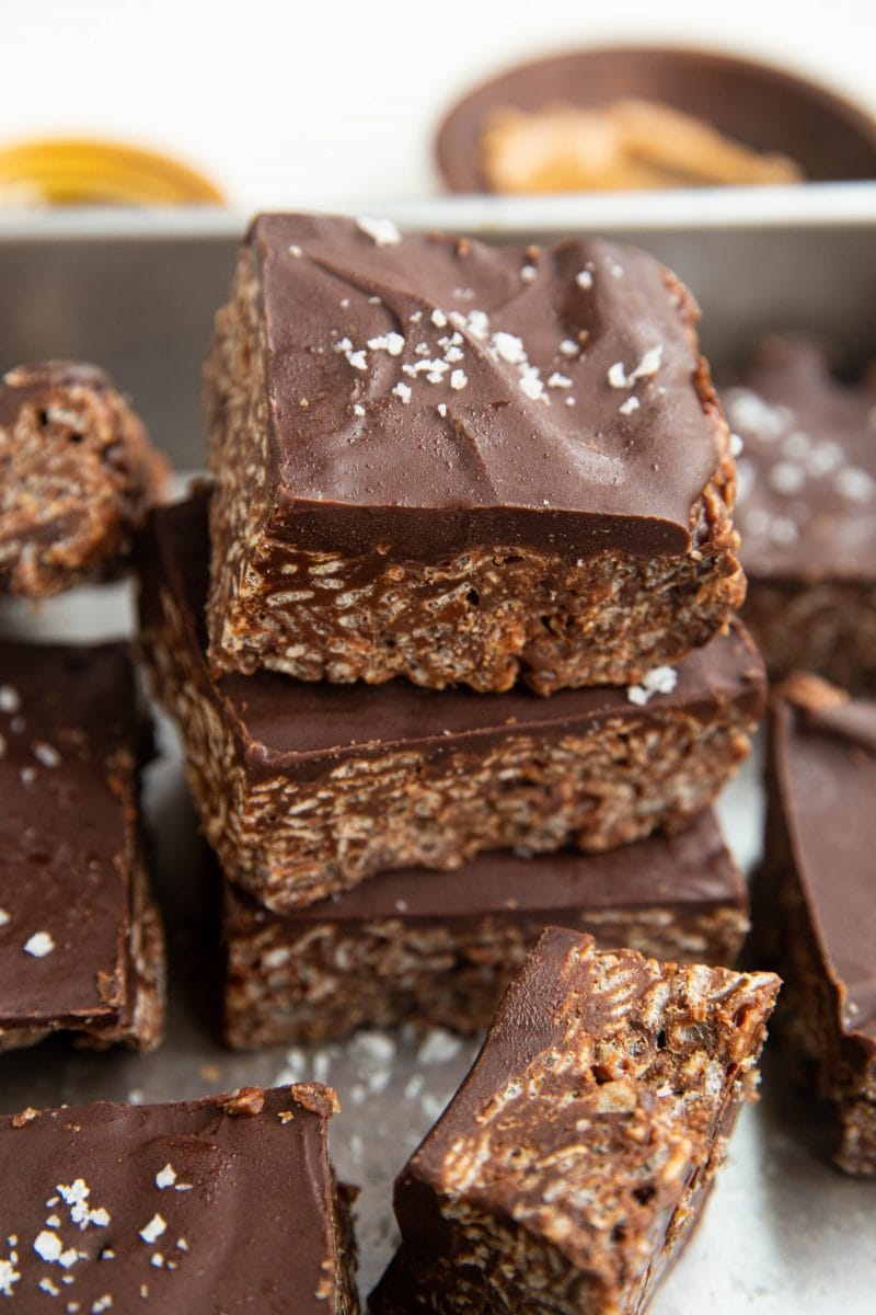 Stack of cereal bars in a baking dish with sea salt sprinkled on top.