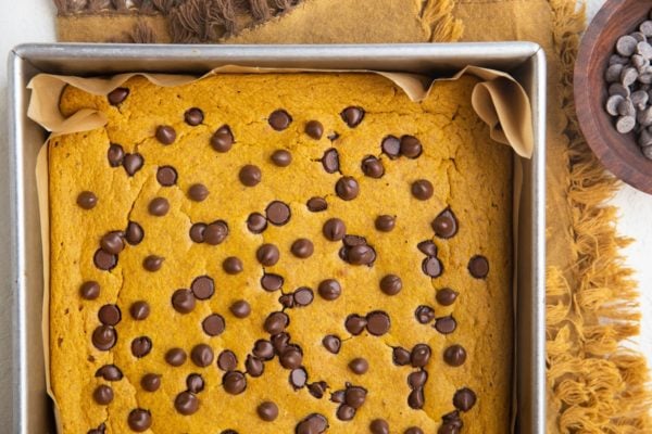 Pumpkin baked oats fresh out of the oven on a golden napkin, cooling to slice.