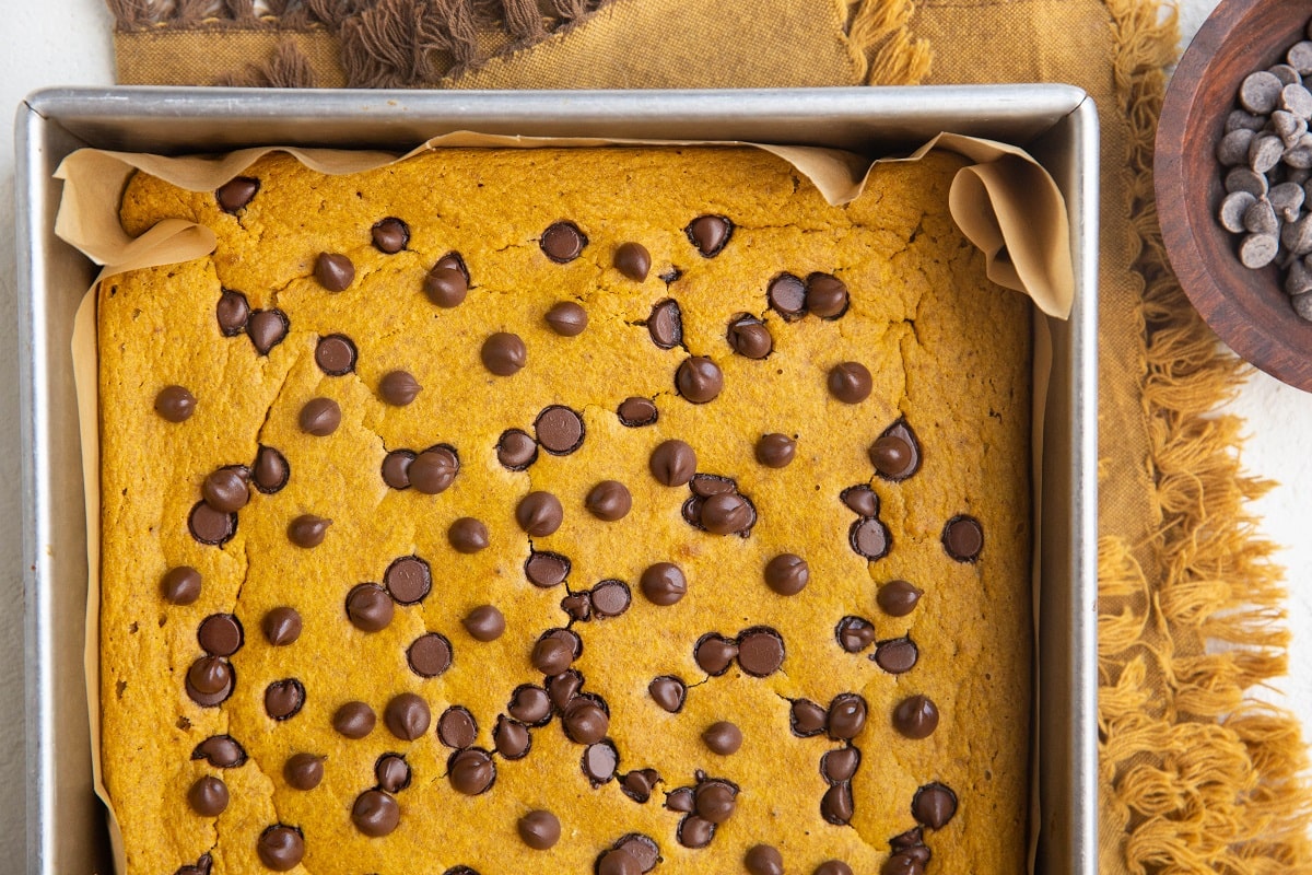 Pumpkin baked oats fresh out of the oven on a golden napkin, cooling to slice.