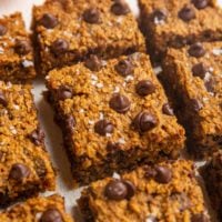 Sliced pumpkin bars on a white backdrop.