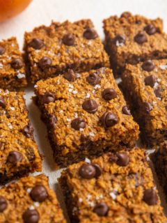 Sliced pumpkin bars on a white backdrop.