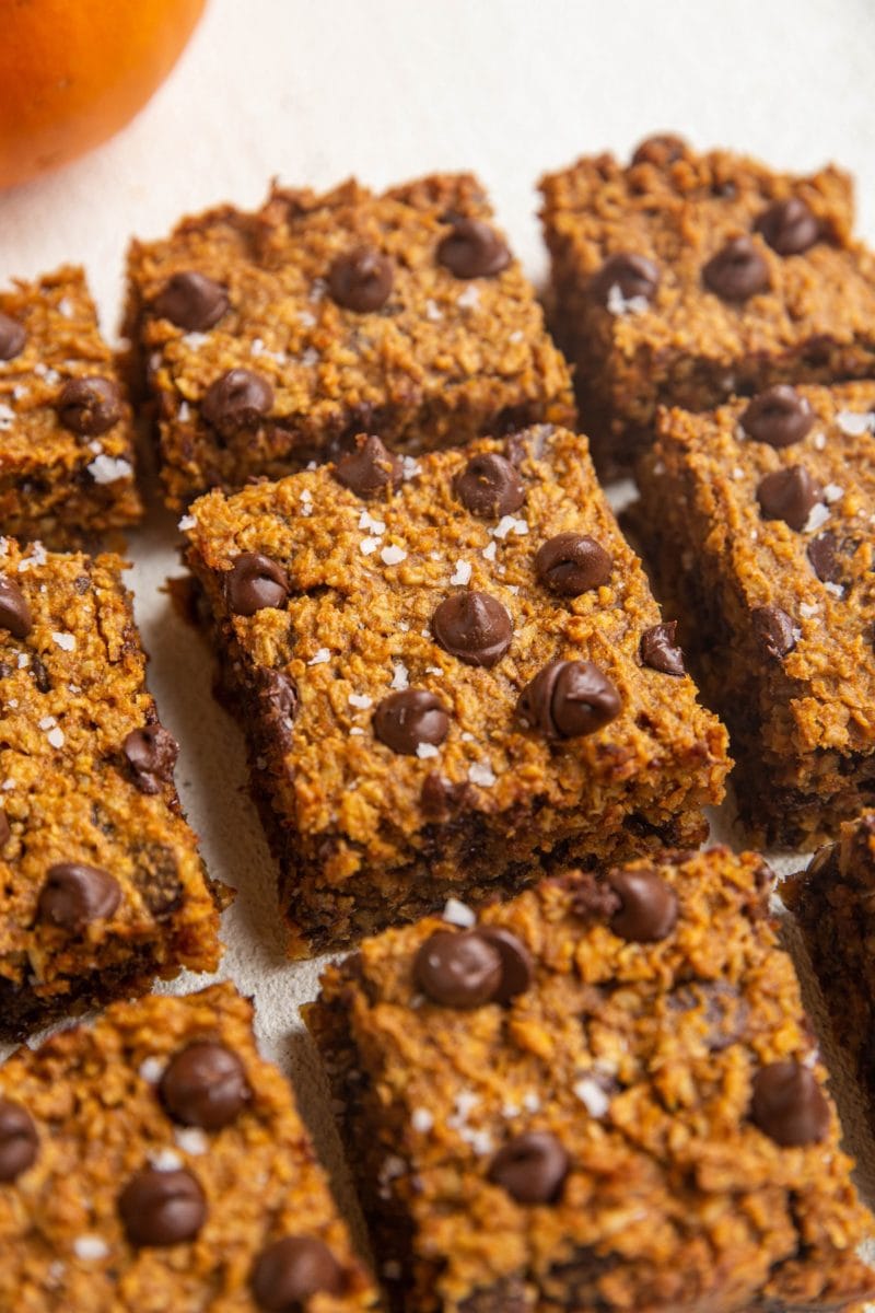 Sliced pumpkin bars on a white backdrop.