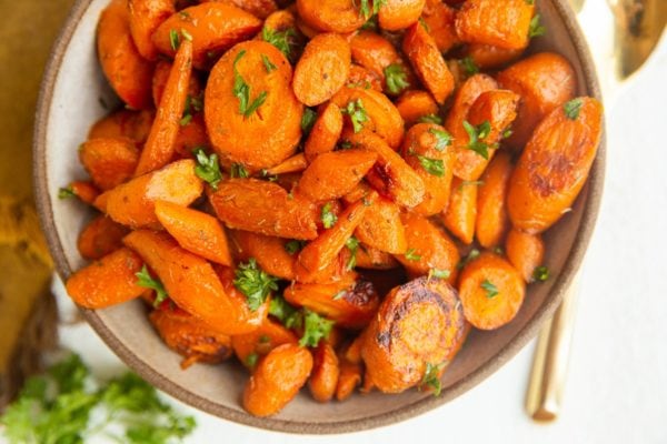 horizonal image of a bowl of roasted carrots