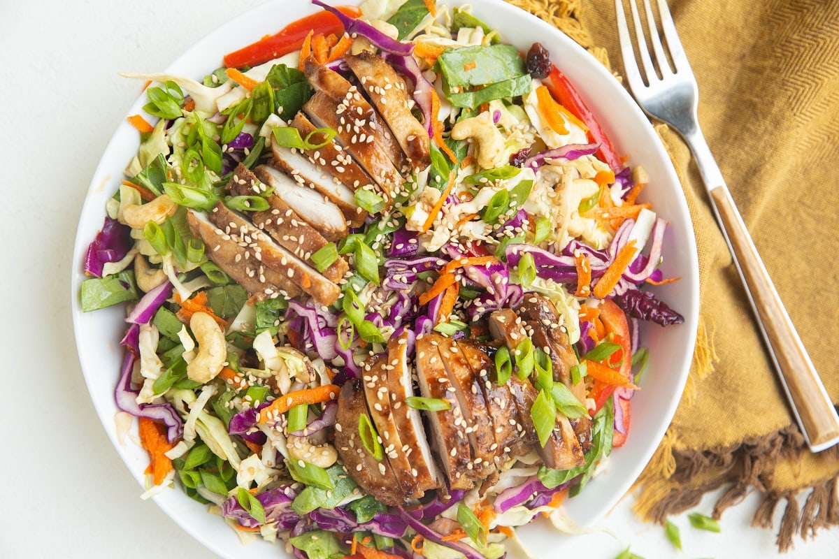 Horizontal photo of white bowl of Asian chicken salad