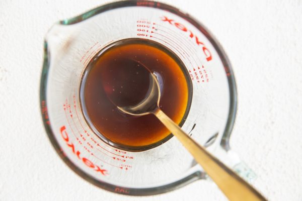 Glaze ingredients stirred together in a measuring cup.