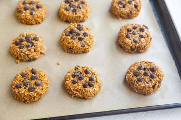 Healthy pumpkin cookies on a baking sheet, ready to go into the oven.