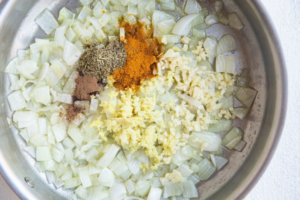 Onion, turmeric, garlic, ginger, dried thyme and cinnamon in a skillet.