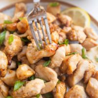 Fork grabbing a chicken bite off a plate