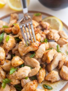 Fork grabbing a chicken bite off a plate