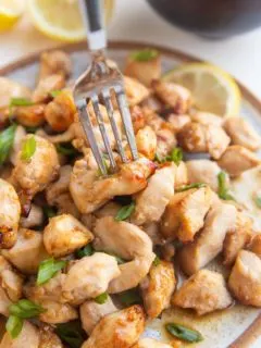 Fork grabbing a chicken bite off a plate