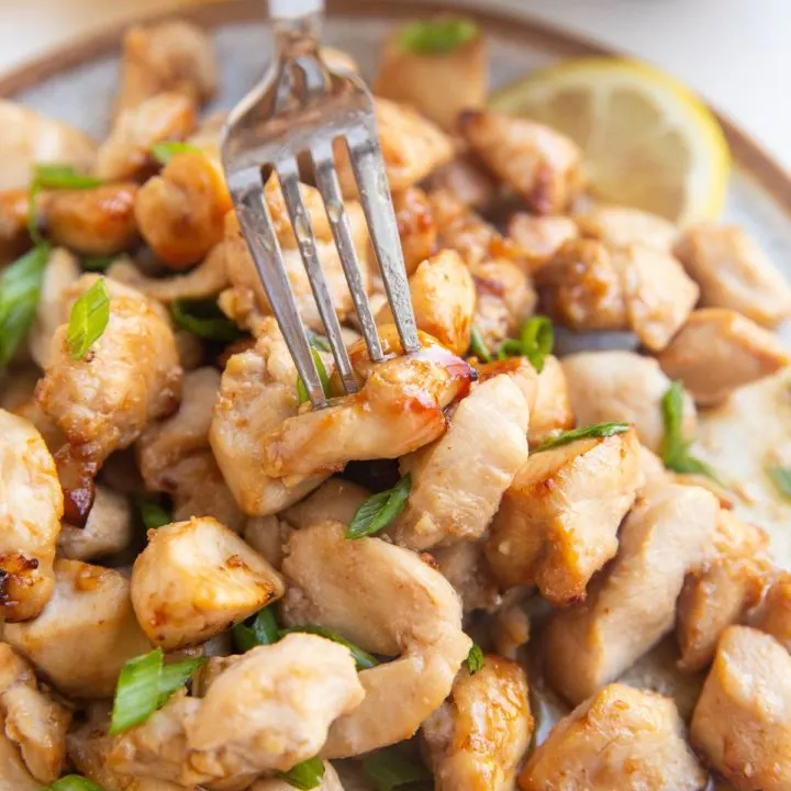 Fork grabbing a chicken bite off a plate