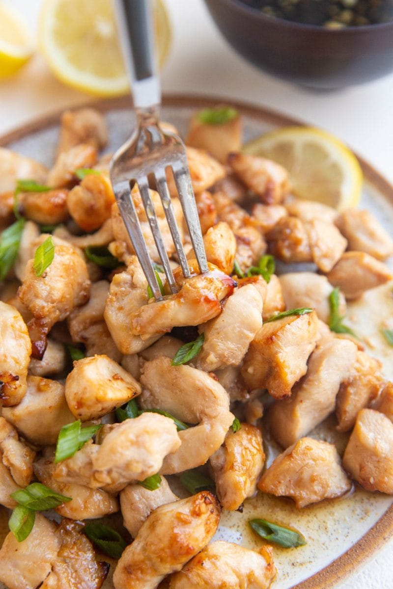 Fork grabbing a chicken bite off a plate