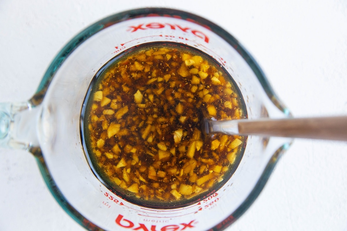 Marinade for air fryer chicken bites stirred up in a measuring cup.