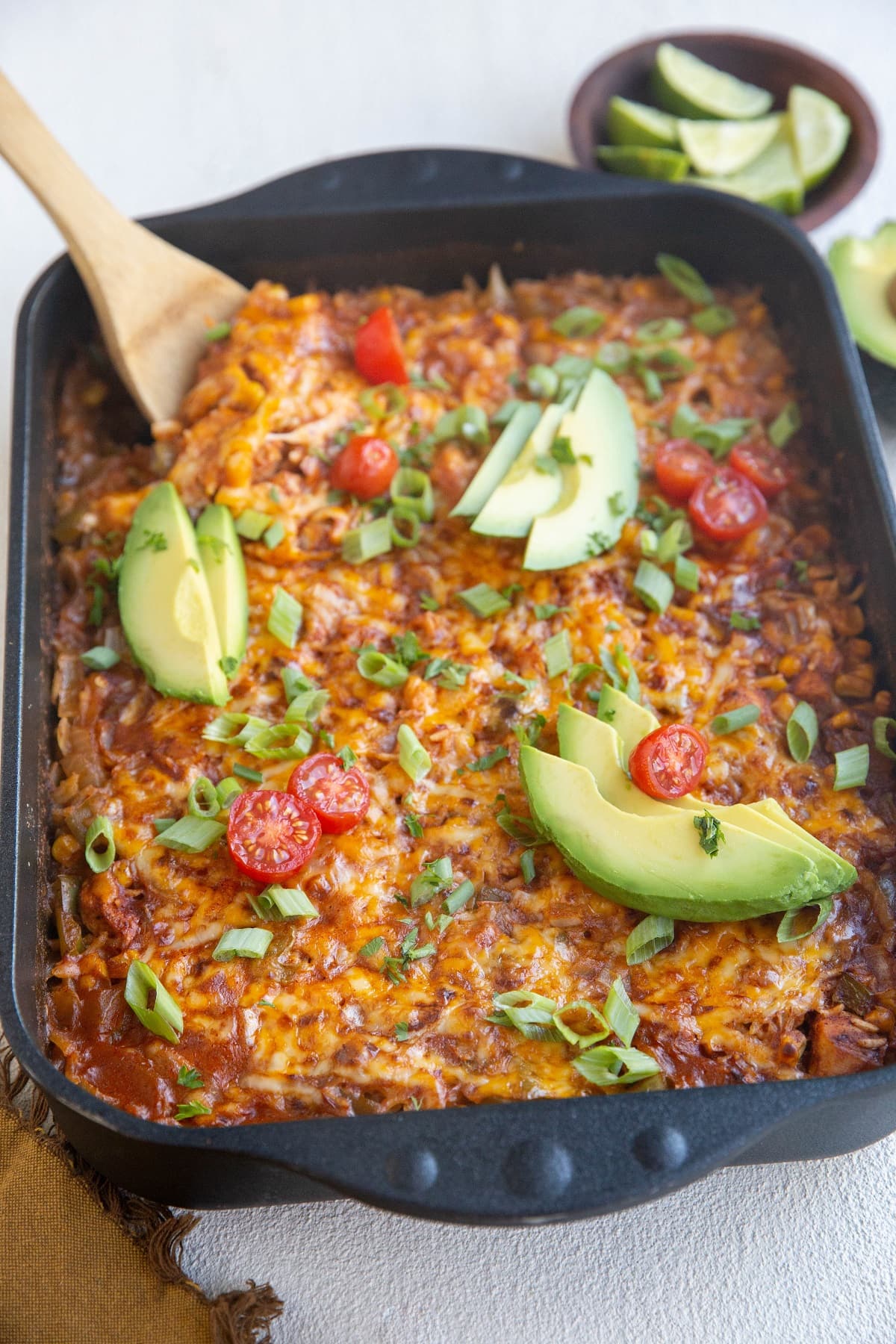 Casserole with a wooden spoon about to take a scoop.