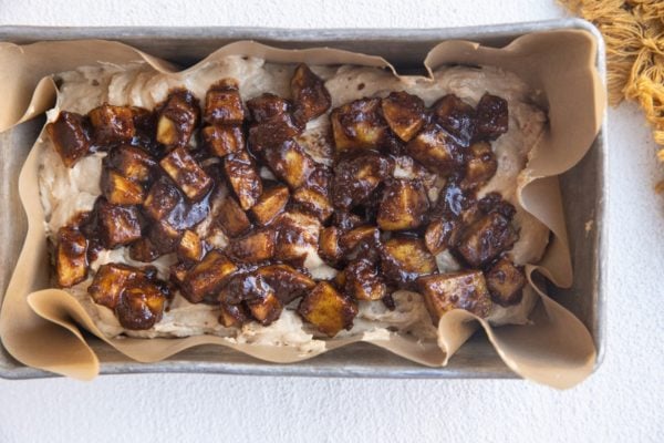 Apple cinnamon chunks on top of the bread dough.