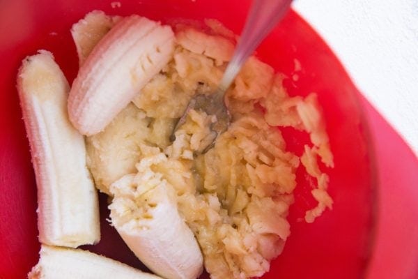 Mashed bananas in a mixing bowl