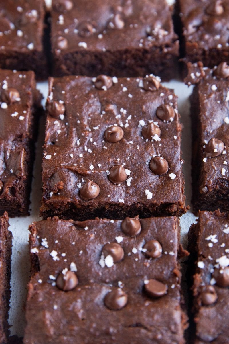 Big hunks of brownies sitting on a white backdrop.