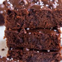 Stack of sweet potato brownies - a closeup on the brownies sprinkled with sea salt.