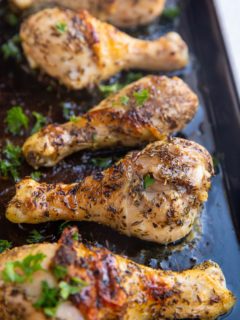 Baking sheet of honey herb chicken drumsticks fresh out of the oven.