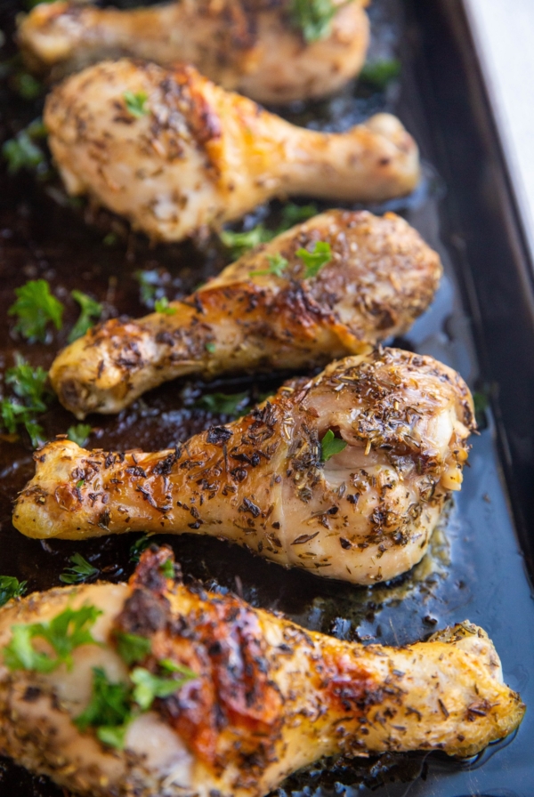 Baking sheet of honey herb chicken drumsticks fresh out of the oven.