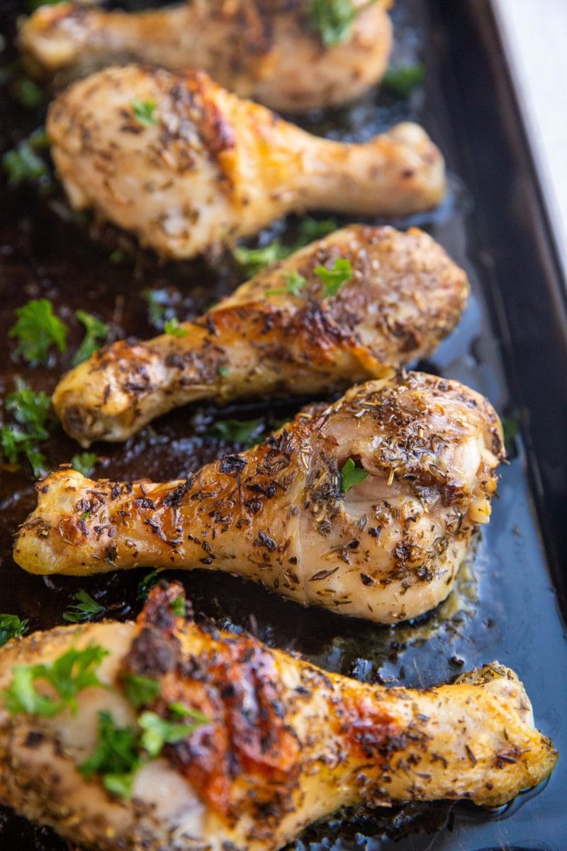 Baking sheet of honey herb chicken drumsticks fresh out of the oven.