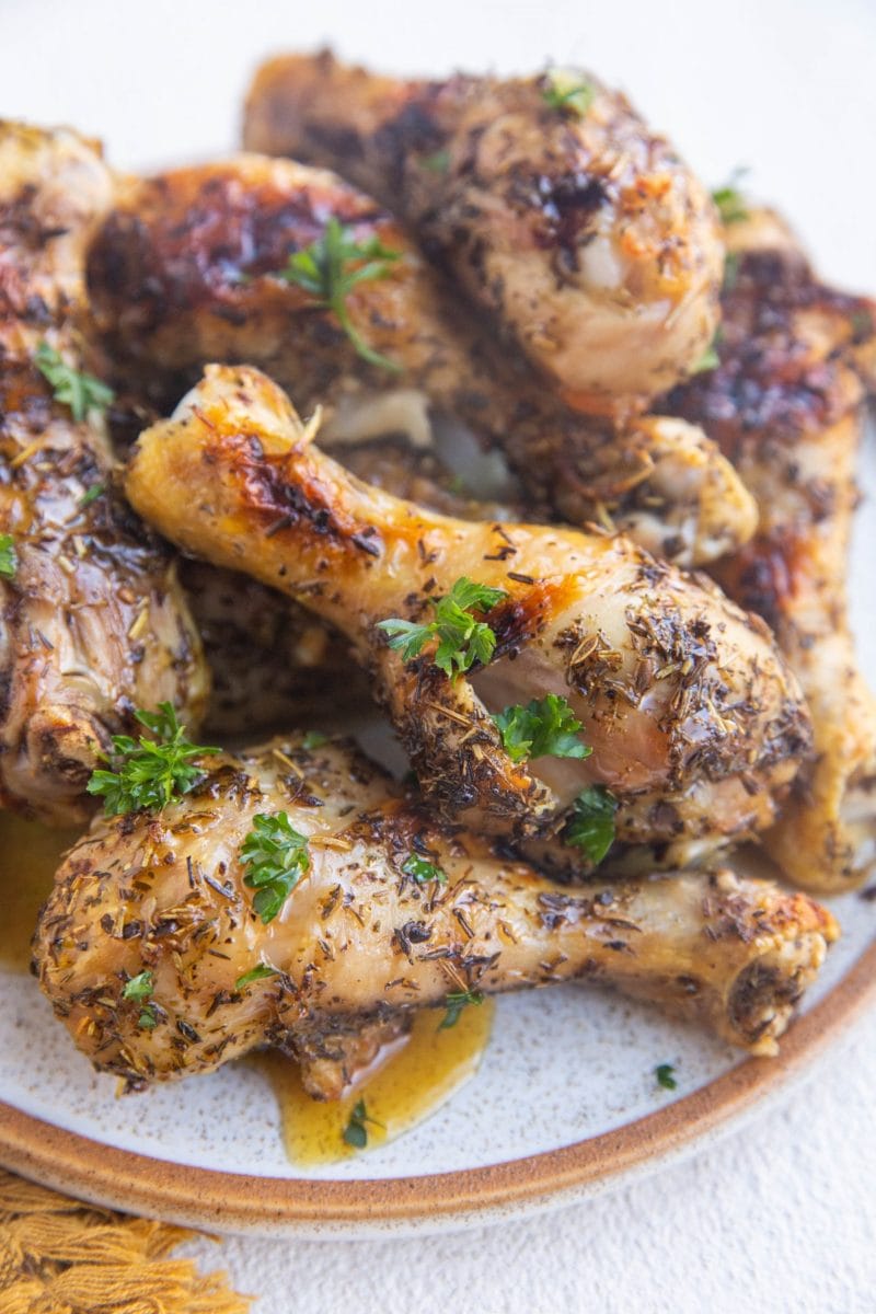 Plate of honey chicken drumsticks.