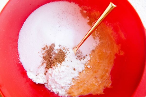 Dry ingredients on top of wet ingredients in a mixing bowl.