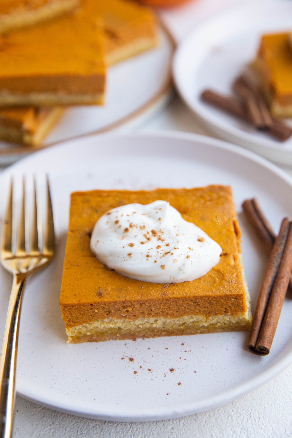 Close up shot of a slice of keto pumpkin pie on a plate, ready to be eaten