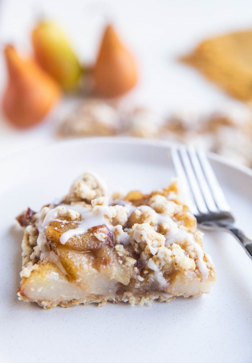 Slice of pear crumb bar on a plate
