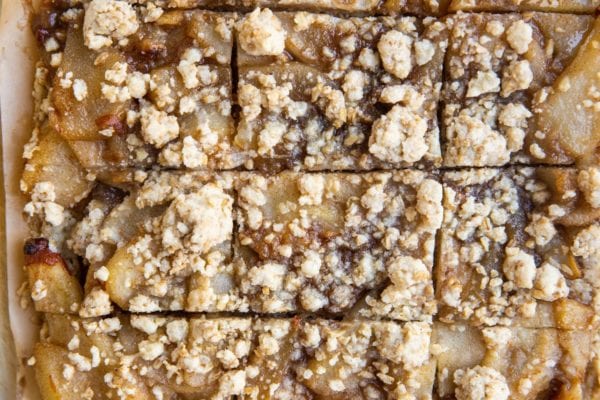 Sliced pear crumb bars on a sheet of parchment paper