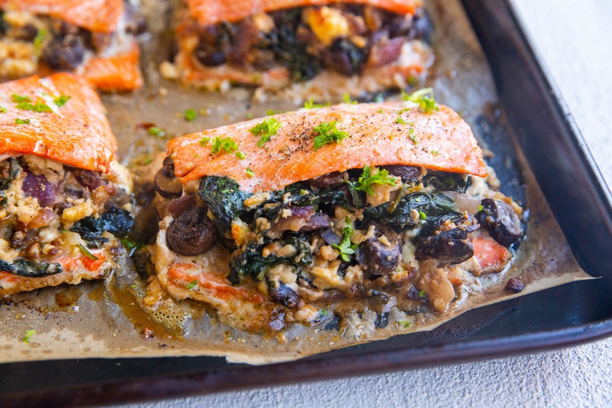 Horizontal image of stuffed salmon, fresh out of the oven, ready to be served.