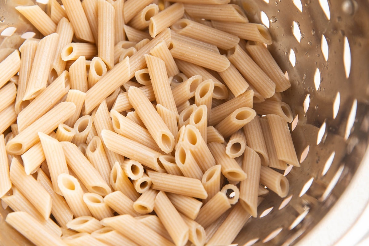 Cooked pasta noodles in a colander.