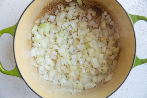 Onion sautéing in a soup pot to make curry soup.