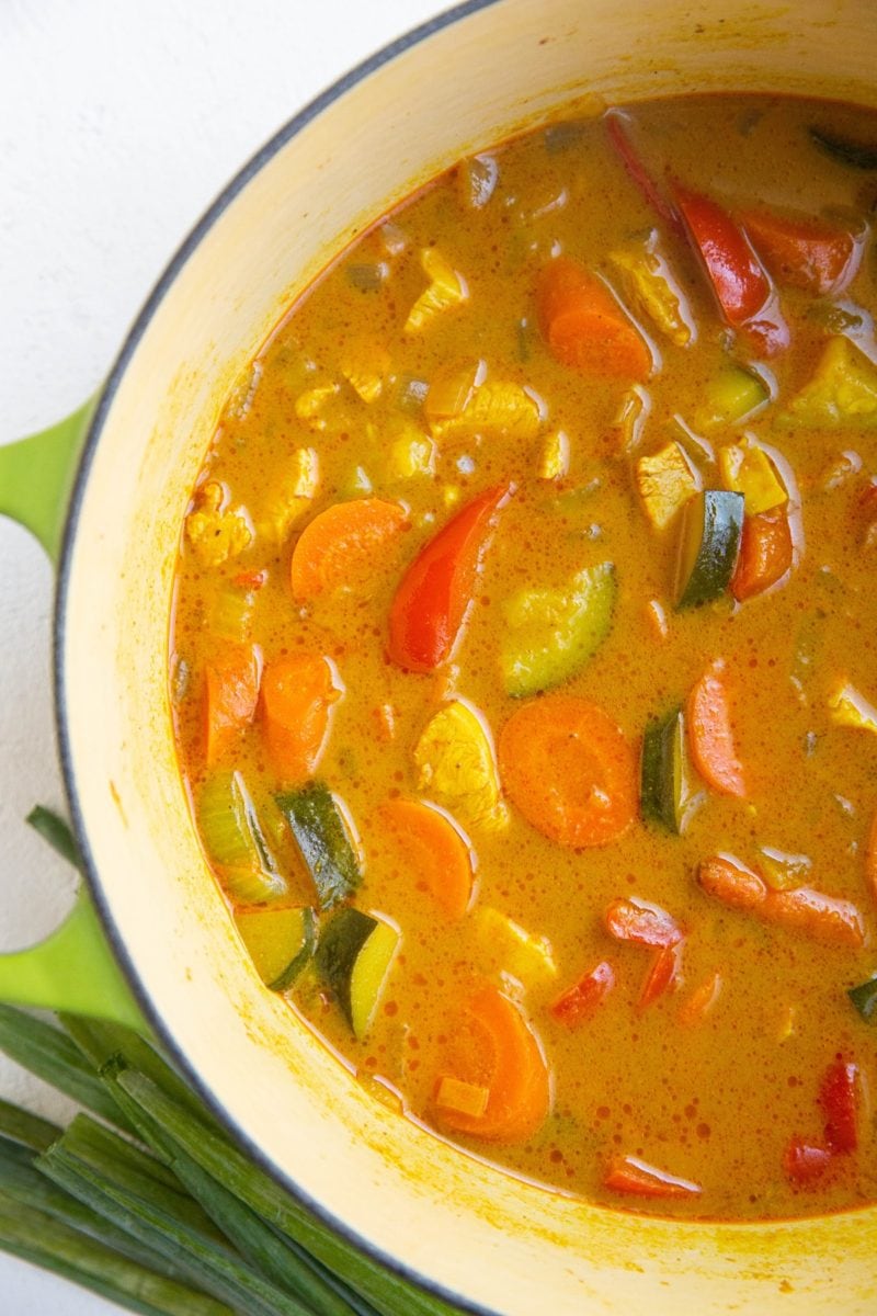 Finished Thai curry soup in a green Dutch oven.