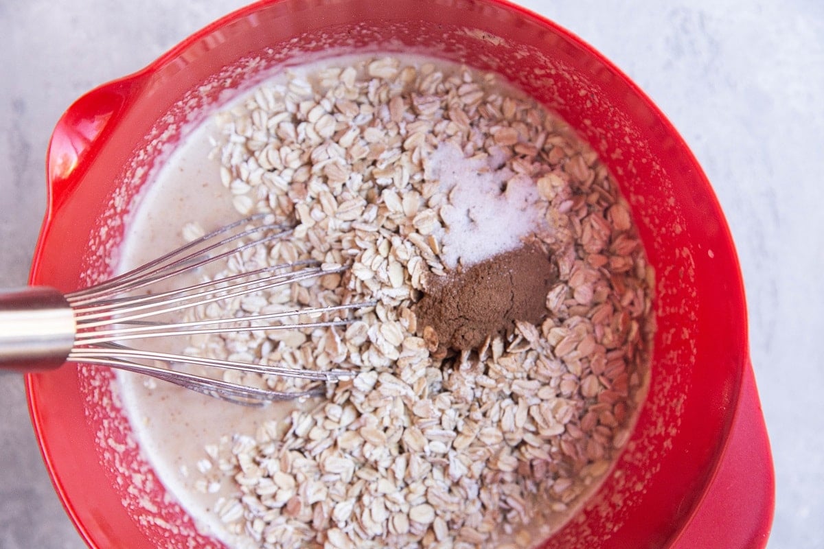 Oats, cinnamon and salt on top of the wet ingredients.