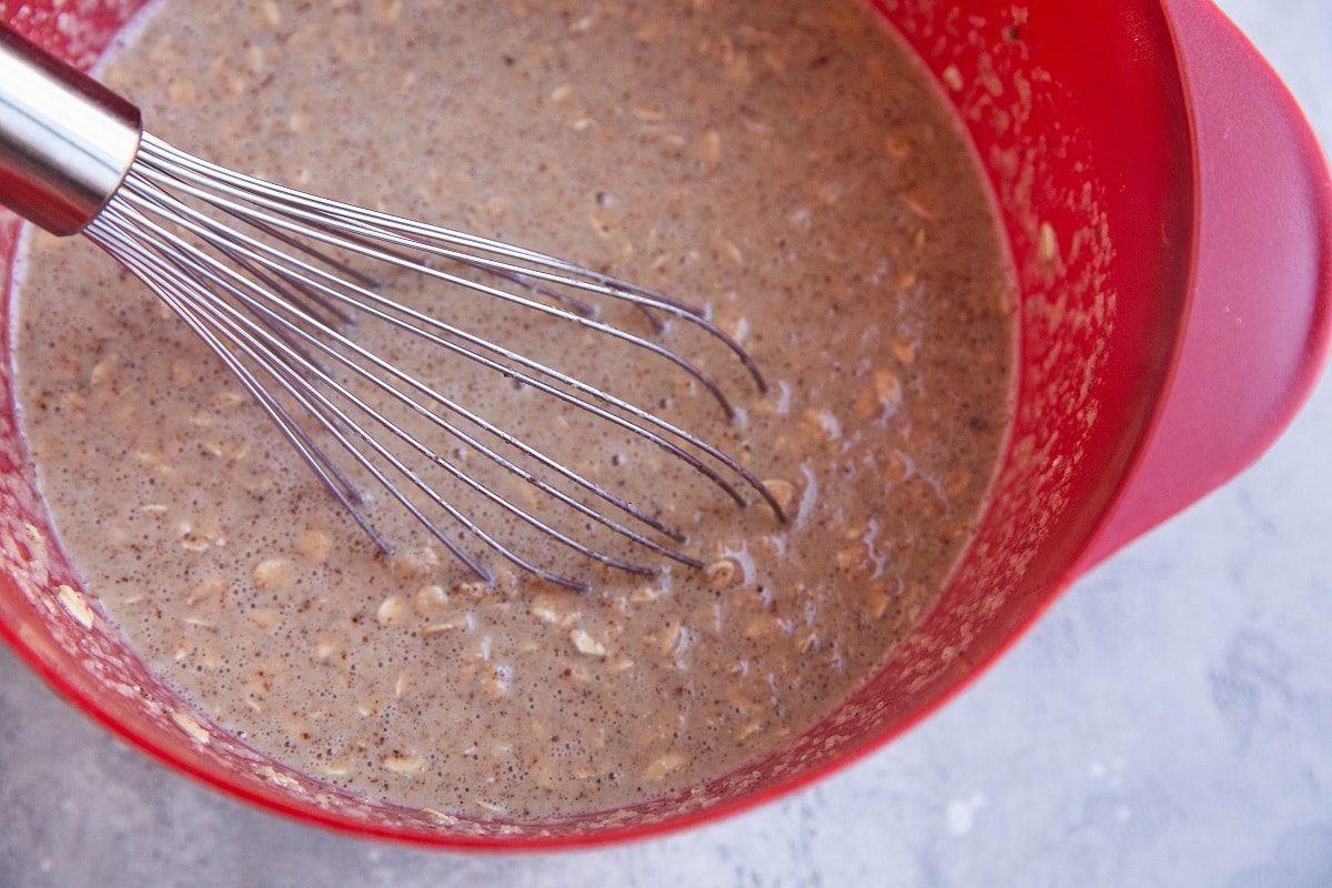 Mixing bowl with apple oatmeal cup mixture, ready to be baked.