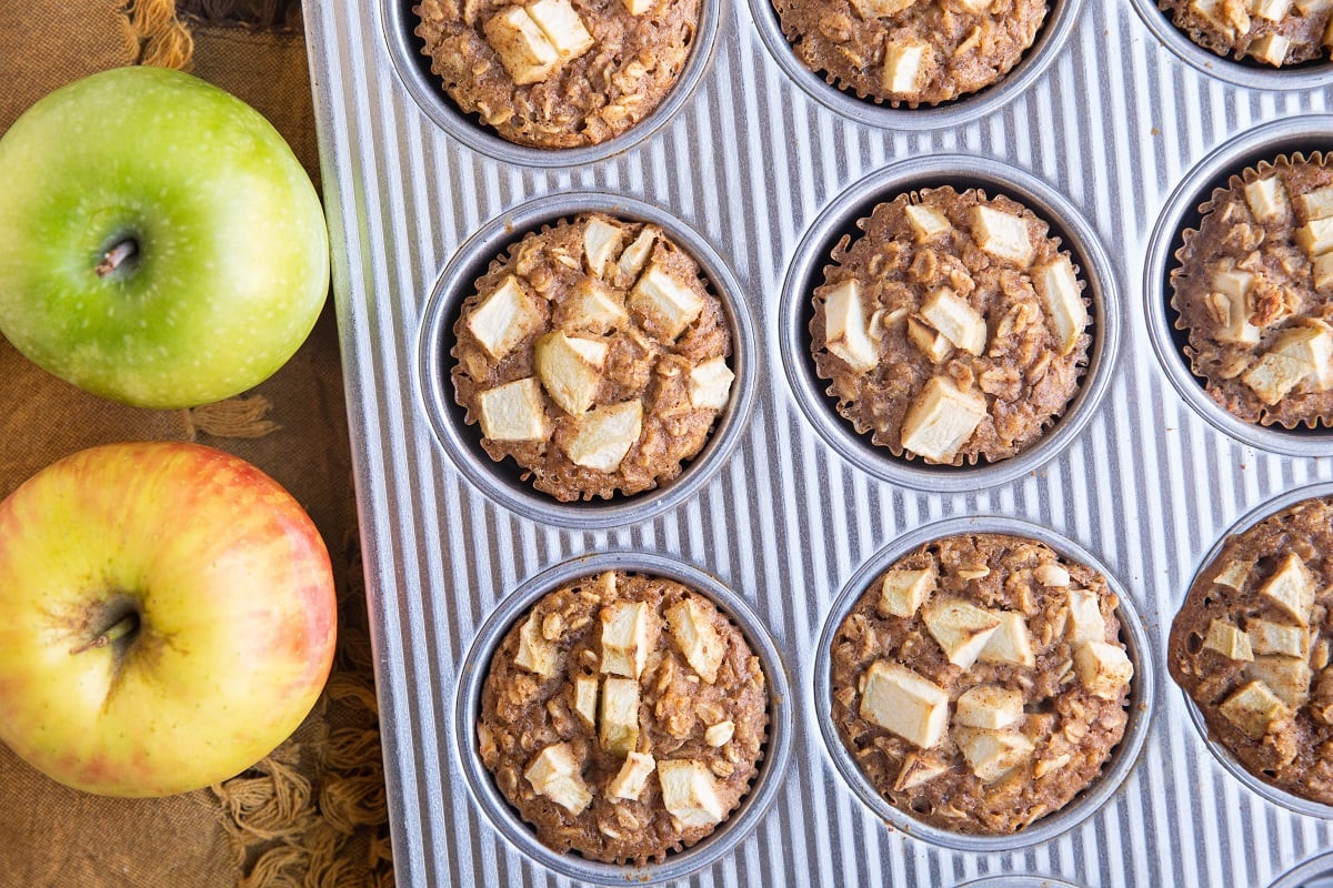 horizontal photo of baked oatmeal cups fresh out of the oven in a muffin tin