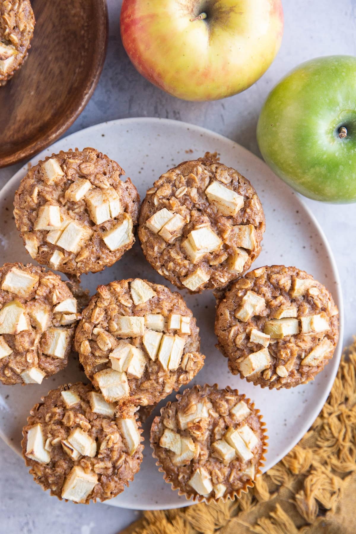 Plate of baked oatmeal cups with apples and a napkin to the side.