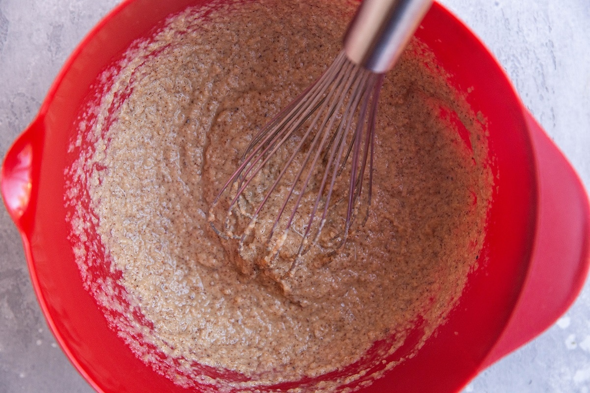 Wet ingredients for apple oatmeal cups in a mixing bowl.