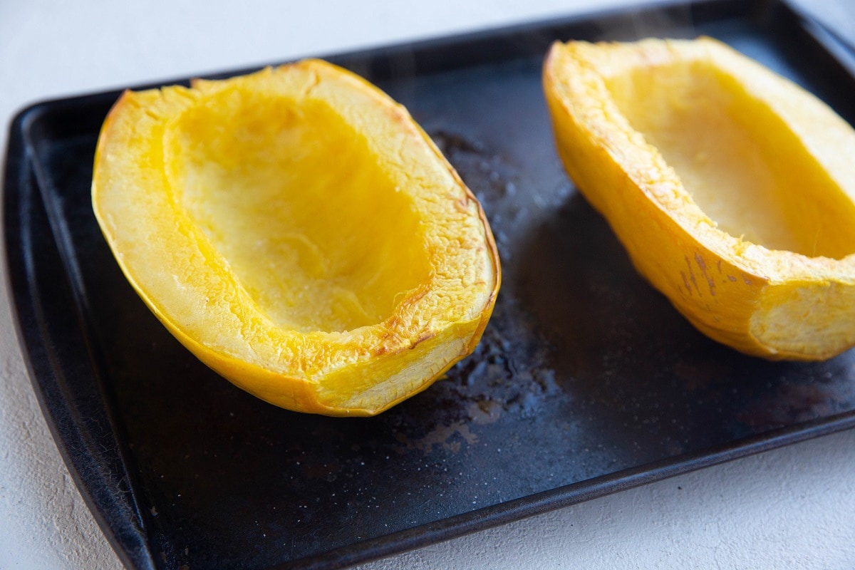 Cooked spaghetti squash on a baking sheet.