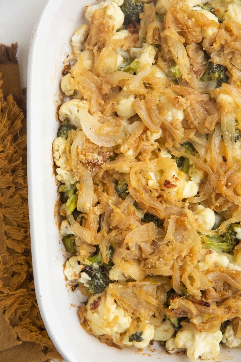 Fresh out of the oven Broccoli Cauliflower Casserole with a golden napkin to the side.