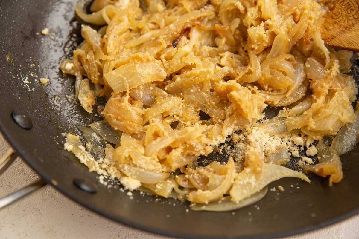 Caramelized onions mixed with almond flour in a skillet