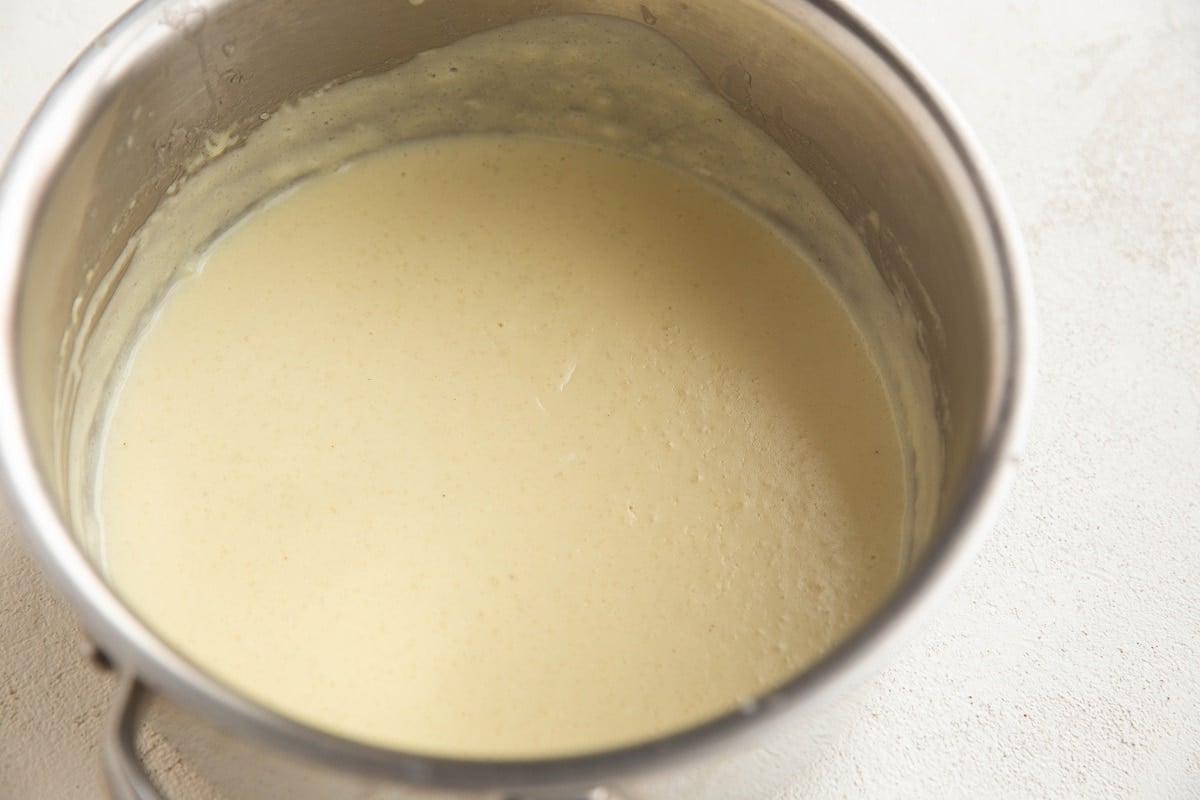 Creamy dairy-free sauce for casserole in a saucepan.