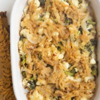 Full casserole dish of broccoli cauliflower casserole with caramelized onions on top.