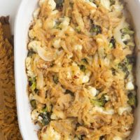 Full casserole dish of broccoli cauliflower casserole with caramelized onions on top.